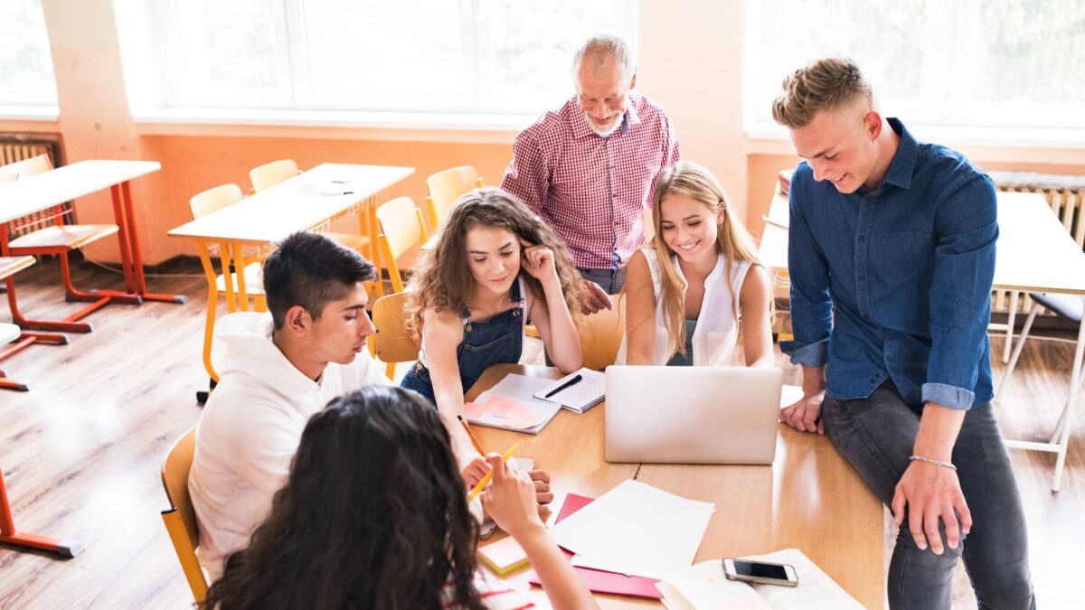 High School Kids around a desk