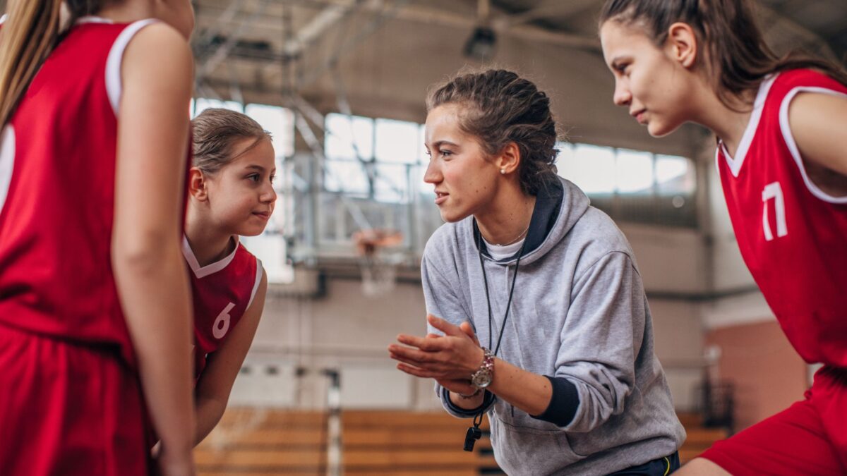 Woman coaching girls basketball